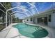 Screened pool with clear water and sunny skies in a tropical backyard at 3487 Cabaret St, Port Charlotte, FL 33948