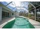 Screened pool with clear water and sunny skies in a tropical backyard at 3487 Cabaret St, Port Charlotte, FL 33948