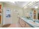 The bathroom features double sinks, and modern lighting for a spa-like experience at 5148 Palena Blvd, North Port, FL 34287