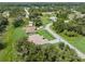 An aerial perspective of the home nestled among trees in its neighborhood at 5366 Dunsmuir Rd, North Port, FL 34288