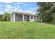 Spacious backyard featuring a large, well-maintained lawn and screened in lanai at 5366 Dunsmuir Rd, North Port, FL 34288