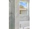 Modern bathroom with a large soaking tub and a walk in shower, featuring marble-like tile at 5366 Dunsmuir Rd, North Port, FL 34288