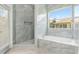 Luxury bathroom with a standalone tub, walk-in shower, and a window with a neighborhood view at 5366 Dunsmuir Rd, North Port, FL 34288