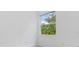Bright bedroom with a large window offering a view of lush, natural surroundings at 5366 Dunsmuir Rd, North Port, FL 34288