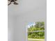 Bright bedroom view showcasing a large window overlooking lush greenery at 5366 Dunsmuir Rd, North Port, FL 34288
