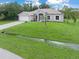 Single-Gathering home featuring well-maintained landscaping, an attached two-car garage, and a pristine driveway at 5366 Dunsmuir Rd, North Port, FL 34288