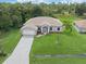 Stunning aerial view of property boasting meticulous landscaping and a lengthy driveway at 5366 Dunsmuir Rd, North Port, FL 34288