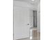 Hallway with gleaming floors and neutral walls leading to more rooms, showcasing a spacious layout at 5366 Dunsmuir Rd, North Port, FL 34288