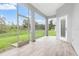 Covered patio with wood-like tile floors and a beautiful view of the surrounding landscape at 5366 Dunsmuir Rd, North Port, FL 34288
