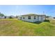 View of the backyard and side of house at 556 Lowell Nw Ave, Port Charlotte, FL 33952