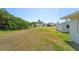 Spacious backyard featuring lush greenery, storage shed and potential for outdoor activities at 556 Lowell Nw Ave, Port Charlotte, FL 33952