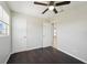 Bedroom with ceiling fan and dark wood floors at 556 Lowell Nw Ave, Port Charlotte, FL 33952