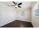 Bedroom with ceiling fan and dark wood floors at 556 Lowell Nw Ave, Port Charlotte, FL 33952