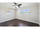 Bedroom with two windows and dark wood floors at 556 Lowell Nw Ave, Port Charlotte, FL 33952