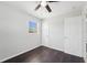 Bedroom with ceiling fan and dark wood floors at 556 Lowell Nw Ave, Port Charlotte, FL 33952