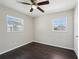 Bedroom featuring wood-look floors, a ceiling fan and two bright windows at 556 Lowell Nw Ave, Port Charlotte, FL 33952