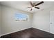This bedroom features a ceiling fan and large window letting in natural light at 556 Lowell Nw Ave, Port Charlotte, FL 33952