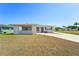 Charming single-story home with a covered entryway and a spacious front yard at 556 Lowell Nw Ave, Port Charlotte, FL 33952