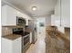 Modern kitchen with stainless steel appliances, granite countertops, and white cabinets at 556 Lowell Nw Ave, Port Charlotte, FL 33952