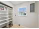 Clean laundry room featuring built-in shelves, a window, and convenient utility connections at 556 Lowell Nw Ave, Port Charlotte, FL 33952