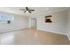 Spacious living room featuring tile floors, neutral paint, large windows, and a ceiling fan at 556 Lowell Nw Ave, Port Charlotte, FL 33952