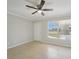 Living room featuring tile flooring, a ceiling fan, and natural light from the window at 556 Lowell Nw Ave, Port Charlotte, FL 33952
