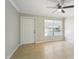 Living room featuring tile flooring, a ceiling fan, and a front door at 556 Lowell Nw Ave, Port Charlotte, FL 33952