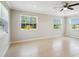 Bright living room with tile floors, a ceiling fan, and large windows offering ample natural light at 556 Lowell Nw Ave, Port Charlotte, FL 33952