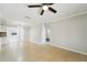 Open concept living area with neutral walls, tiled floors and open view to dining and kitchen at 556 Lowell Nw Ave, Port Charlotte, FL 33952