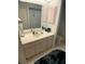 Bathroom vanity featuring a marble countertop, cabinets, and large mirror at 6170 David Blvd, Port Charlotte, FL 33981