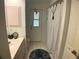 Bathroom featuring a toilet, shower with striped curtain, and marble countertop at 6170 David Blvd, Port Charlotte, FL 33981