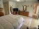 Bedroom featuring a large bed, dressers, and a view into the bathroom at 6170 David Blvd, Port Charlotte, FL 33981
