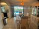 Dining room with view of the pool, modern light fixture, and adjacent kitchen area at 6170 David Blvd, Port Charlotte, FL 33981