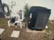 Exterior equipment including a KROLL pool heater, pipes, electrical components, and a small palm tree next to stucco wall at 6170 David Blvd, Port Charlotte, FL 33981