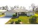 Charming single-story home featuring a well-manicured lawn and mature landscaping with a two car garage at 6170 David Blvd, Port Charlotte, FL 33981