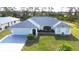 Charming single-story home featuring a well-manicured lawn and mature landscaping with a two car garage at 6170 David Blvd, Port Charlotte, FL 33981
