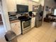 Modern kitchen with stainless steel appliances and white cabinetry at 6170 David Blvd, Port Charlotte, FL 33981