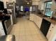 Open kitchen with tile floors and stainless steel appliances at 6170 David Blvd, Port Charlotte, FL 33981