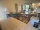 Open-concept living room with tile flooring and inviting seating areas that lead to the dining room at 6170 David Blvd, Port Charlotte, FL 33981