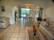Bright living and dining area with tile flooring and sliding glass doors to the pool at 6170 David Blvd, Port Charlotte, FL 33981