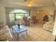 Comfortable living room featuring tile flooring, a large window, and two plush chairs at 6170 David Blvd, Port Charlotte, FL 33981