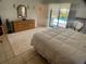 Light-filled main bedroom with access to the pool area and a neutral-colored rug at 6170 David Blvd, Port Charlotte, FL 33981
