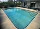 The swimming pool has steps and a ladder for access with an outdoor seating area at 6170 David Blvd, Port Charlotte, FL 33981