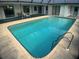 The swimming pool is surrounded by a patio and has a ladder for easy access at 6170 David Blvd, Port Charlotte, FL 33981