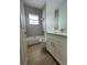 This bathroom has a tub, toilet, vanity, framed mirror, and a window that lets in natural light at 6372 Grove Blvd, Punta Gorda, FL 33982