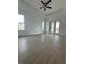 This bedroom has wood-style tile flooring, a ceiling fan, and sliding glass doors to a lanai at 6372 Grove Blvd, Punta Gorda, FL 33982