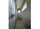 This walk-in shower has gray tile surround, pebble flooring, and a shower head at 6372 Grove Blvd, Punta Gorda, FL 33982