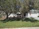 Charming single-story home featuring a well-manicured lawn, crisp white paint, and an American flag at 710 Aqui Esta Dr, Punta Gorda, FL 33950
