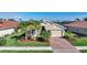 Charming single-Gathering home featuring a brick driveway and a well-manicured lawn with tropical landscaping at 7346 Talon Bay Dr, North Port, FL 34287