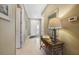 Inviting hallway with tile flooring, console table and neutral paint at 7346 Talon Bay Dr, North Port, FL 34287